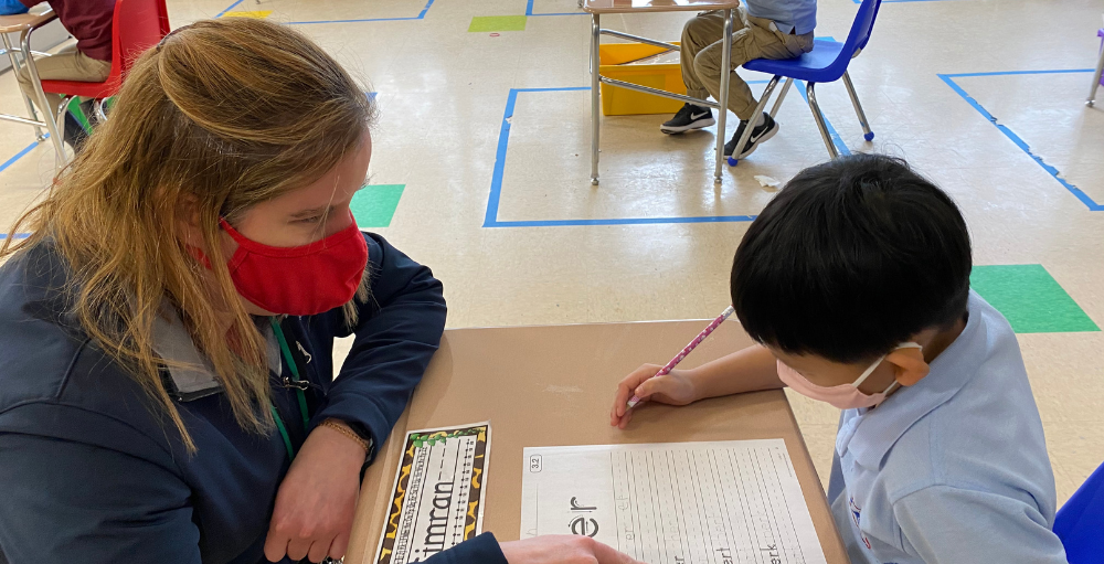 Syracuse Academy of Science and Citizenship first grade Atoms practice their reading and writing skills by completing various phonics worksheets.