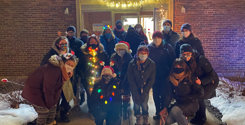 Syracuse Academy of Science and Citizenship school teachers pose for a group picture following their successful Winter Wonderland drive through event for their students and the Syracuse community.