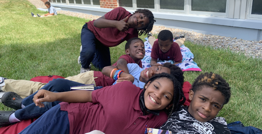 Syracuse Academy of Science and Citizenship elementary school’s 4th-grade students kick off their ‘Fun Day’ with an outdoor Read-A-Thon.
