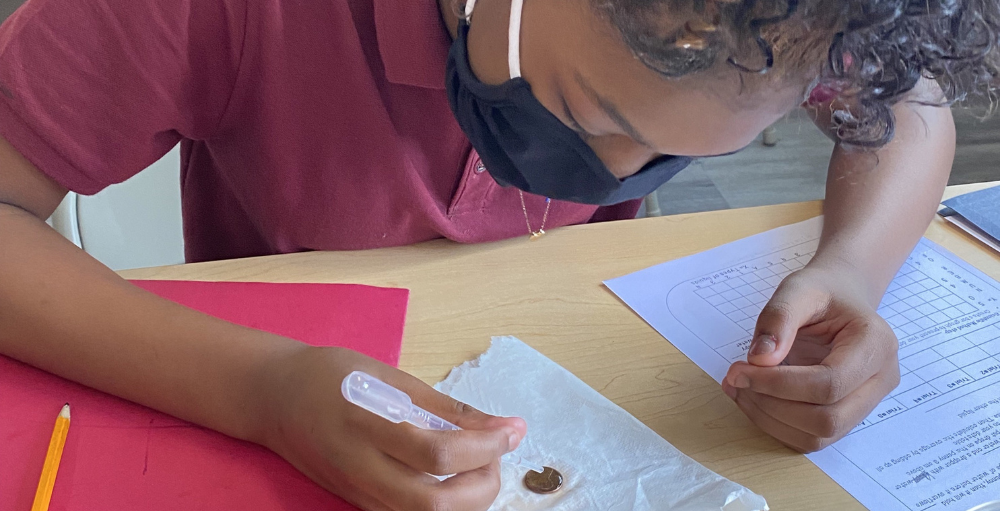 Syracuse Academy of Science and Citizenship 6th grade students conducted a science experiment in which they counted the number of water droplets that can fit on the side of a penny.