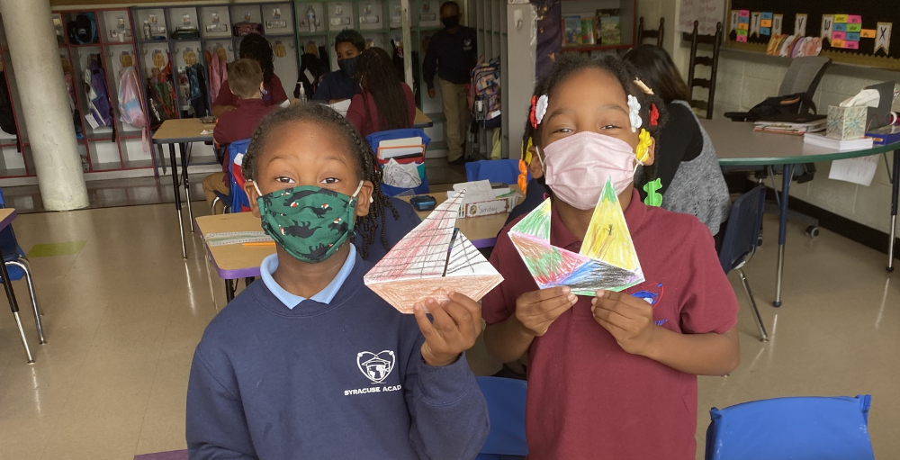 Syracuse Academy of Science and Citizenship second grade students create their own origami boats following their lesson about ancient civilizations. 