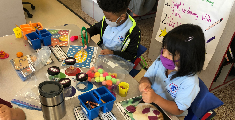 Syracuse Academy of Science and Citizenship kindergarten students practice their fine motor skills with various activities and items in their morning tubs.
